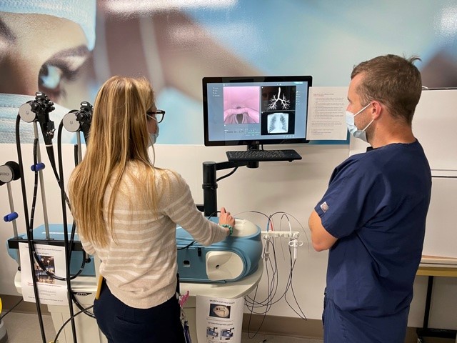 Dr. Pappal navigates a flexible bronchoscopy simulation for foreign body removal under the tutelage of Dr. Azbell.