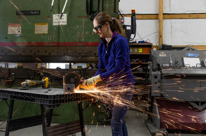 Jessica Moore in her family's welding shop, grinding metal.