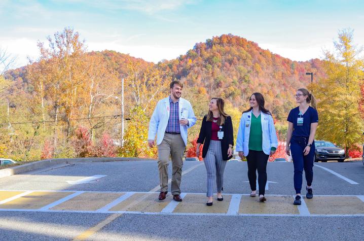 UK students from the Rural Physician Leadership Program walking out on a road in the mountains.