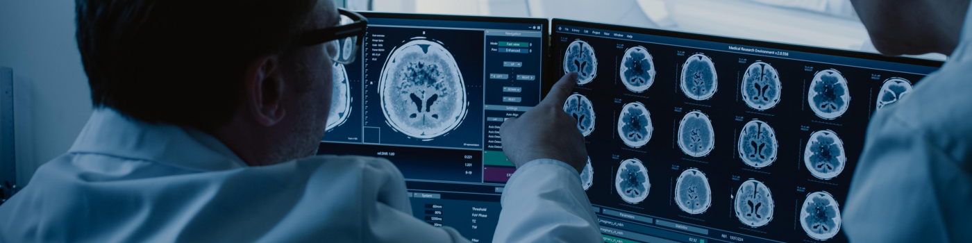 Physicians looking over brain scans.