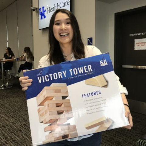 Misa Ito at a UK Health Care event, holding her prize -  Victory Tower game