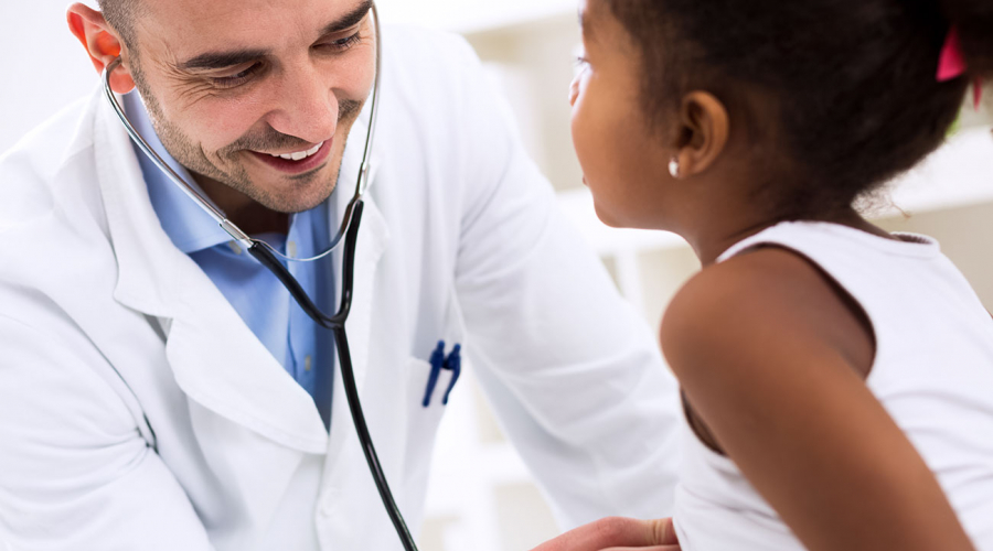 doctor listening to child's heart with stethoscope