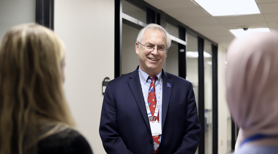 Photo of Dr. Griffith smiling and talking with others