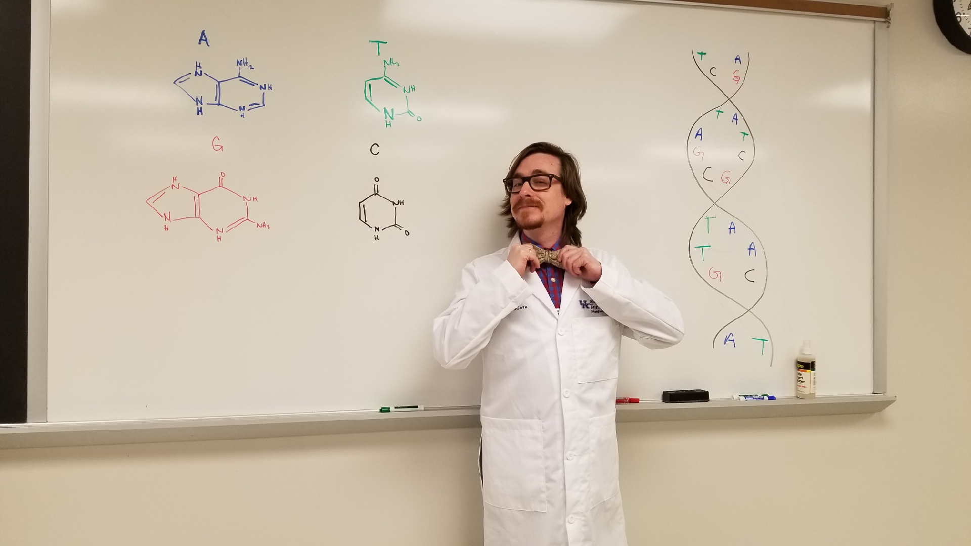 Biochemistry student adjusting bowtie.