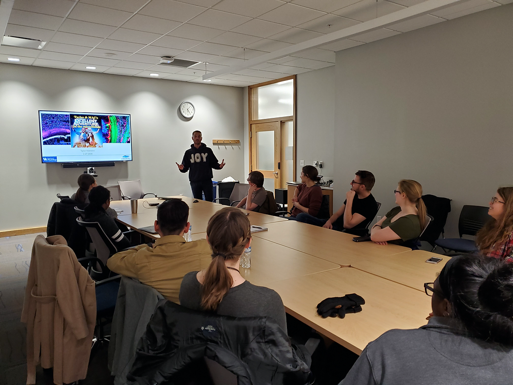 ASM chapter meeting. People sitting around table looking at PowerPoint on research over the microbiome.