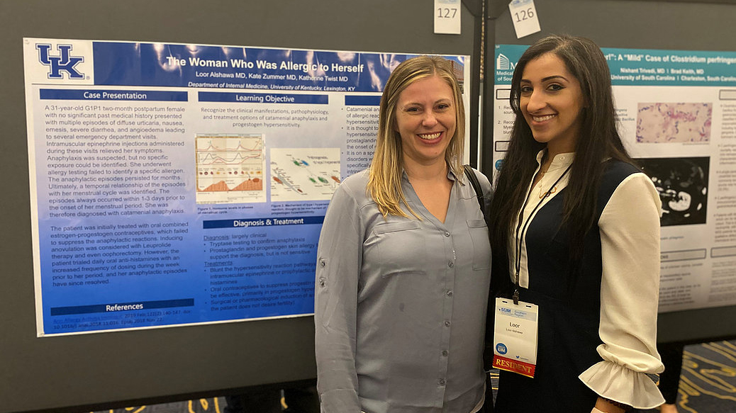 2 women's health residents presenting their care reports at a national conference