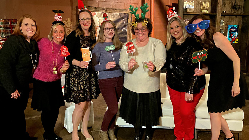 group of women's health team posing for a picture at a holiday party