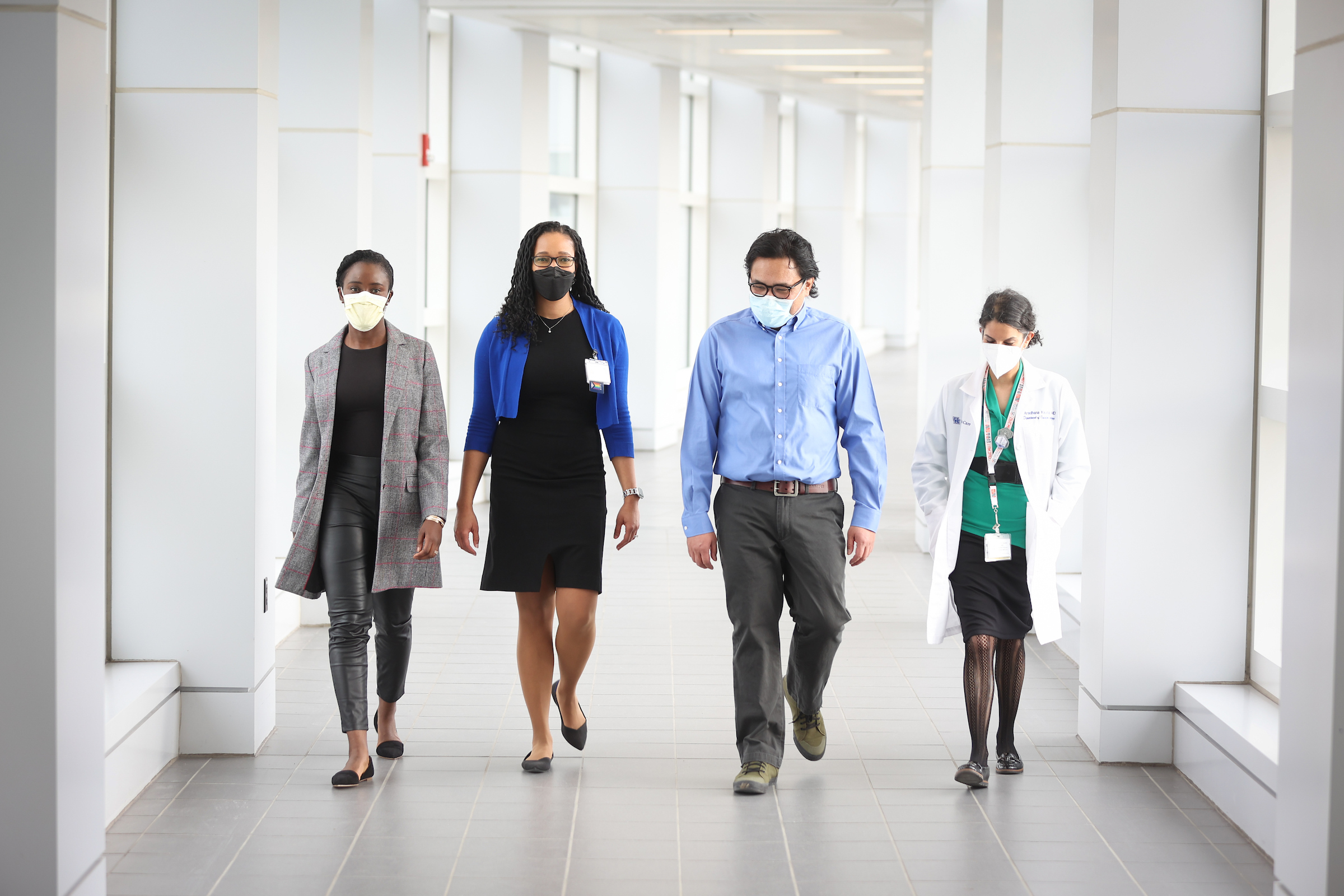 four faculty members walking together