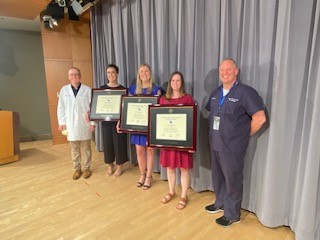 Our 2022 graduates pose with Dr. Scottie Day, Chair of Pediatrics (Left) and Dr. Peter Giannone, Neonatology Division Chief (right)
