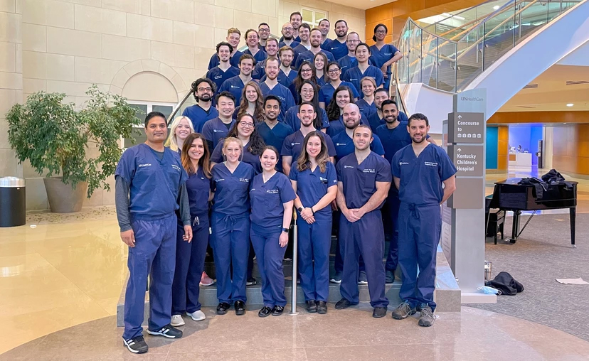 Group of UK EM residents posing on a staircase