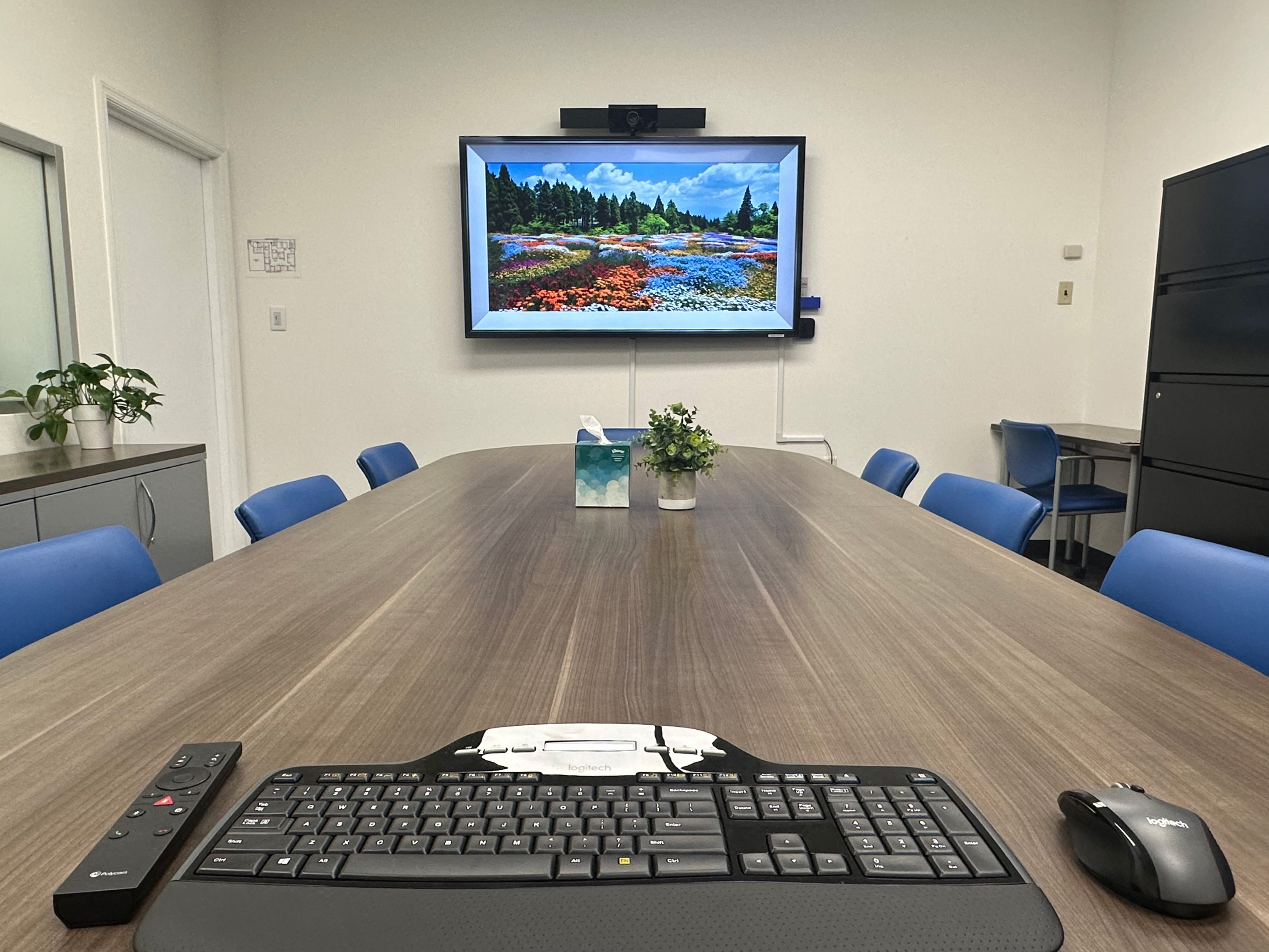 Conference room with monitor, keyboard, and presentation tools