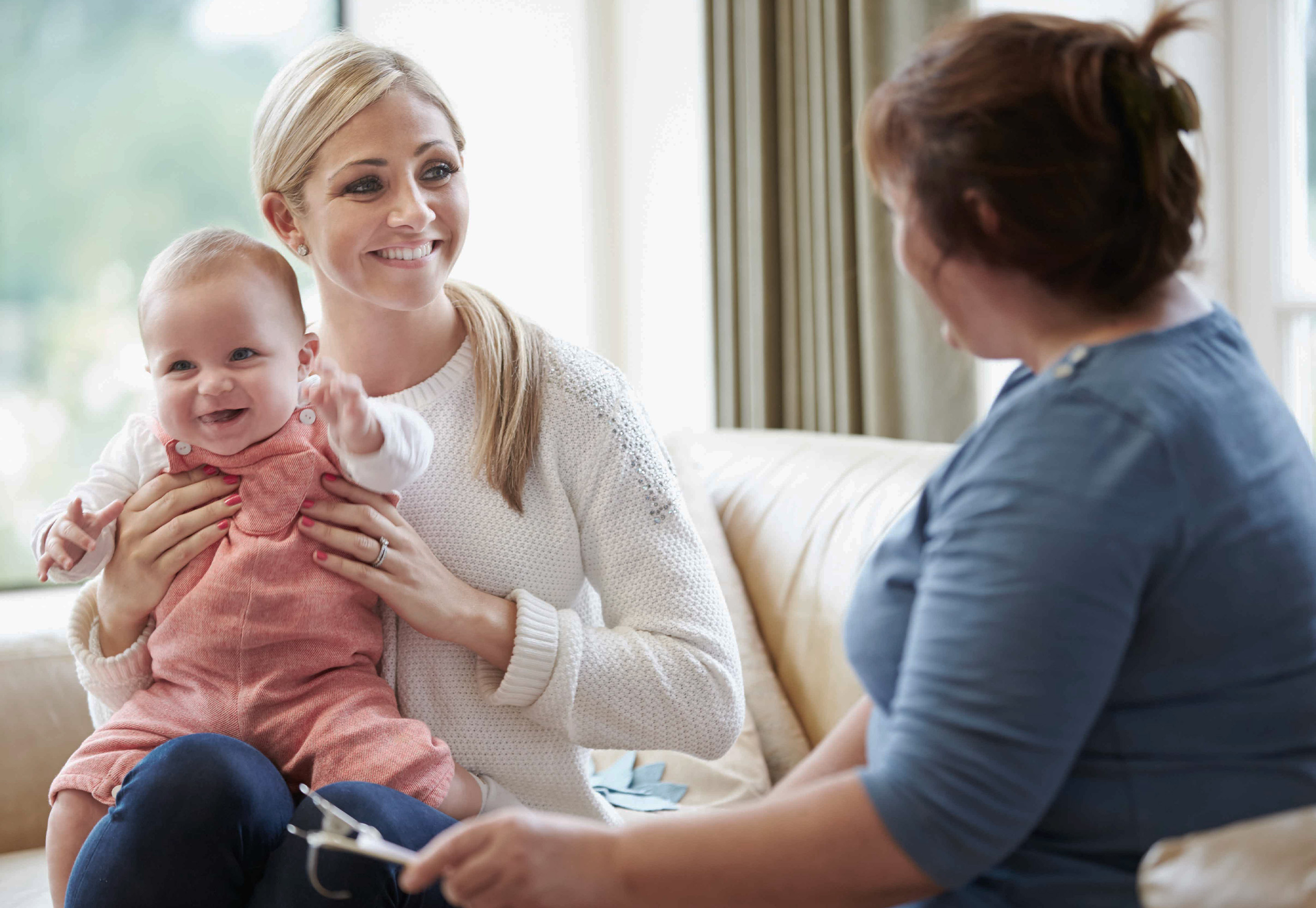 Mother and baby having an at-home doctor's visit.