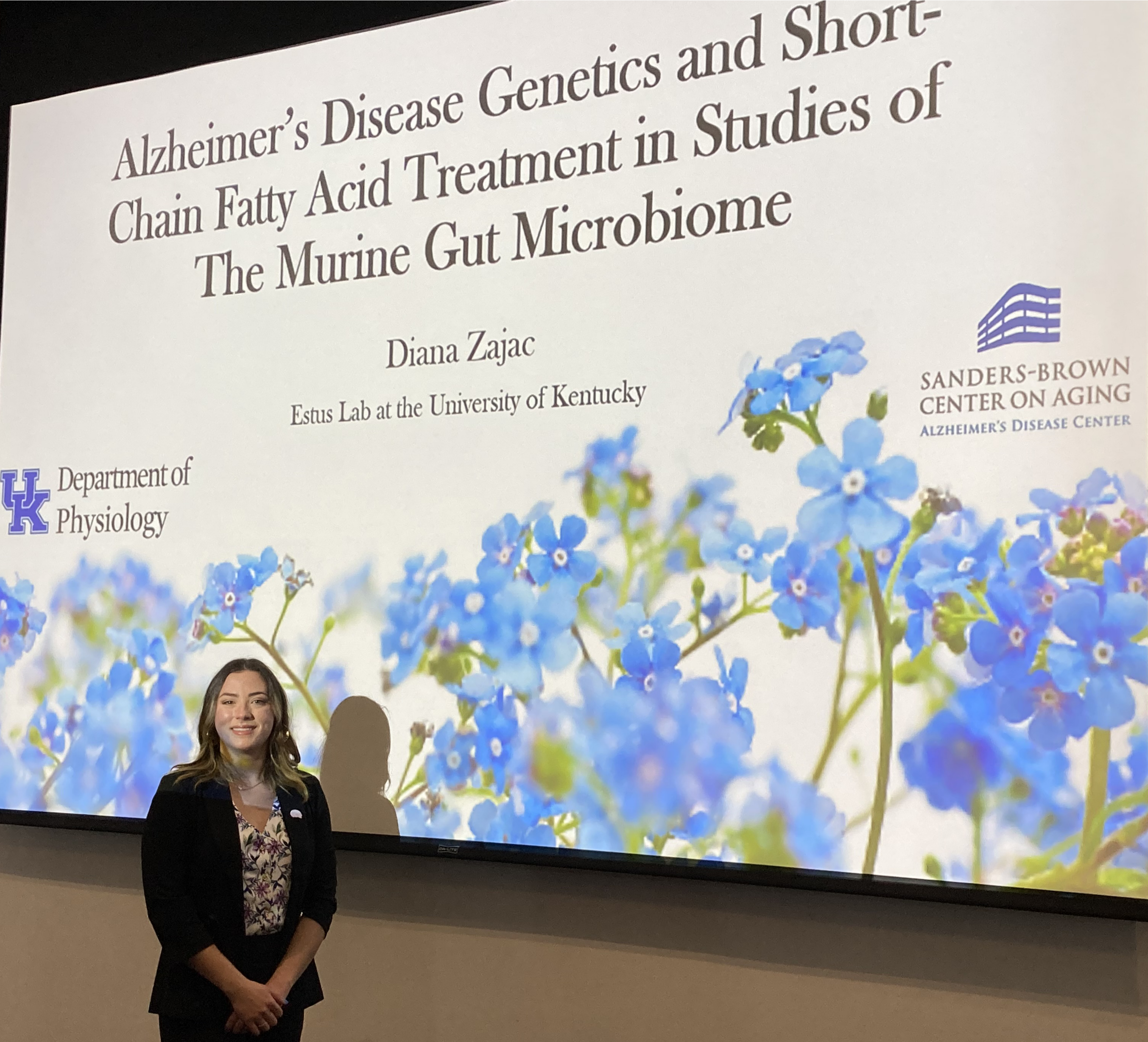 Diana Zajac, PhD in front of her presentation.