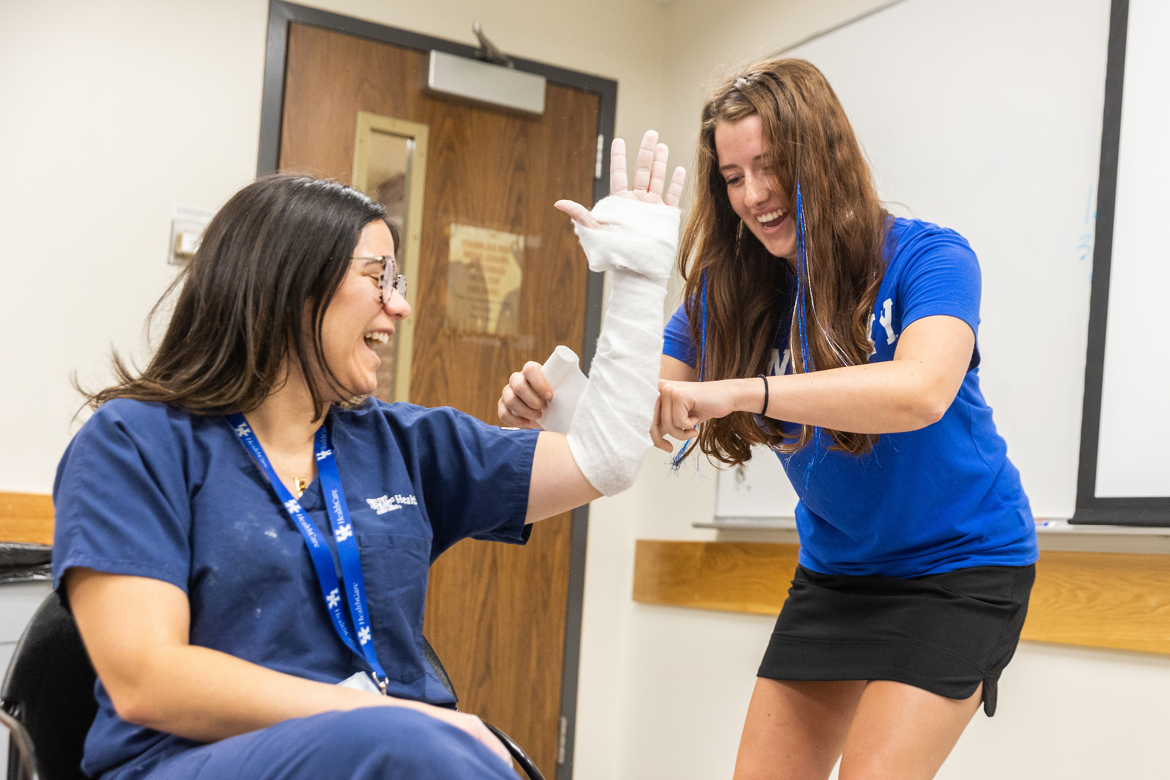 Cristina Rivera-Ramirez, MD, shows UKMED participant how to make a splint.