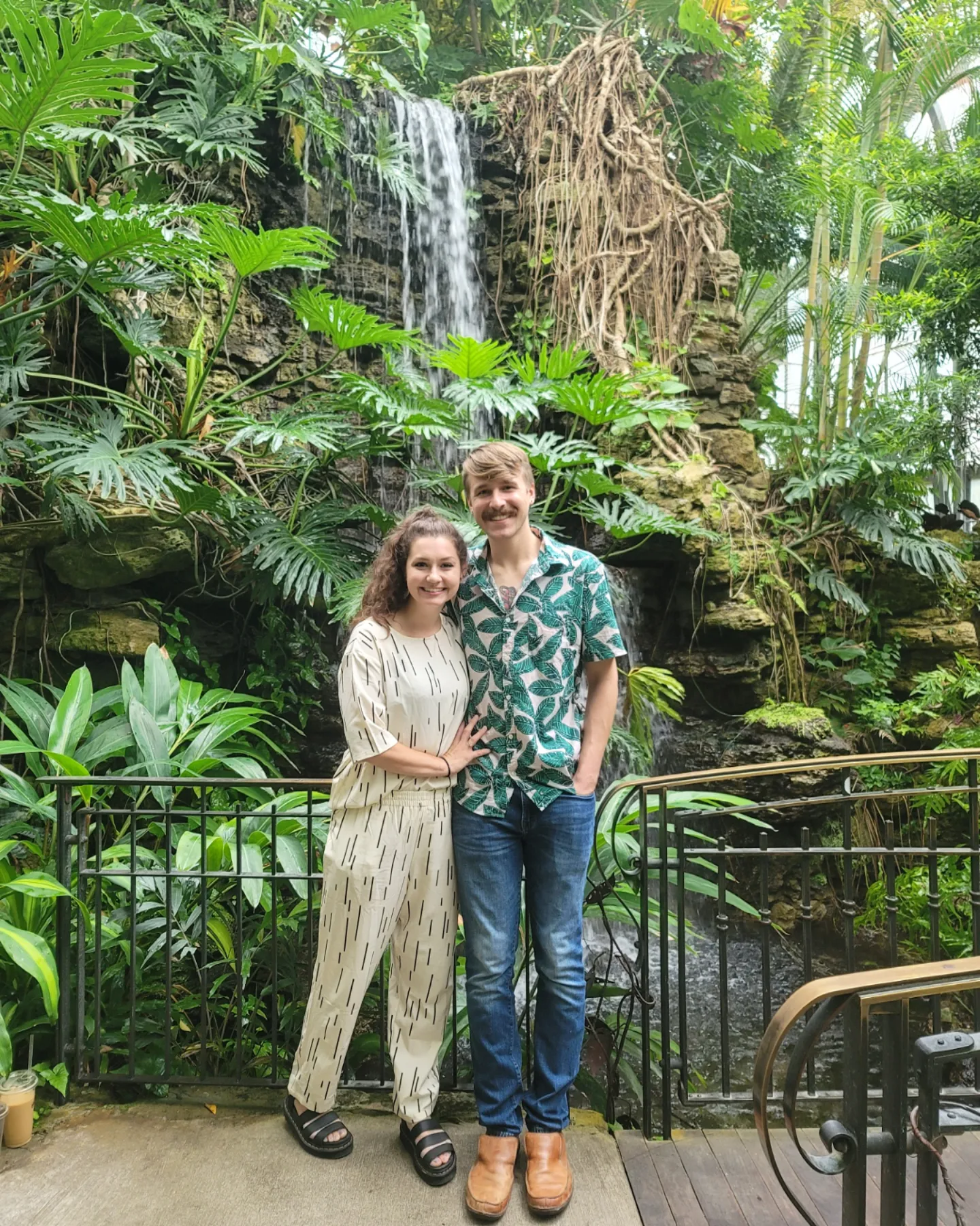 Clay Huffman and His wife posing in greenery