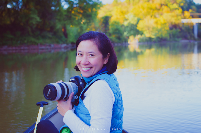 Dr. Sithisarn canoeing and holding her camera