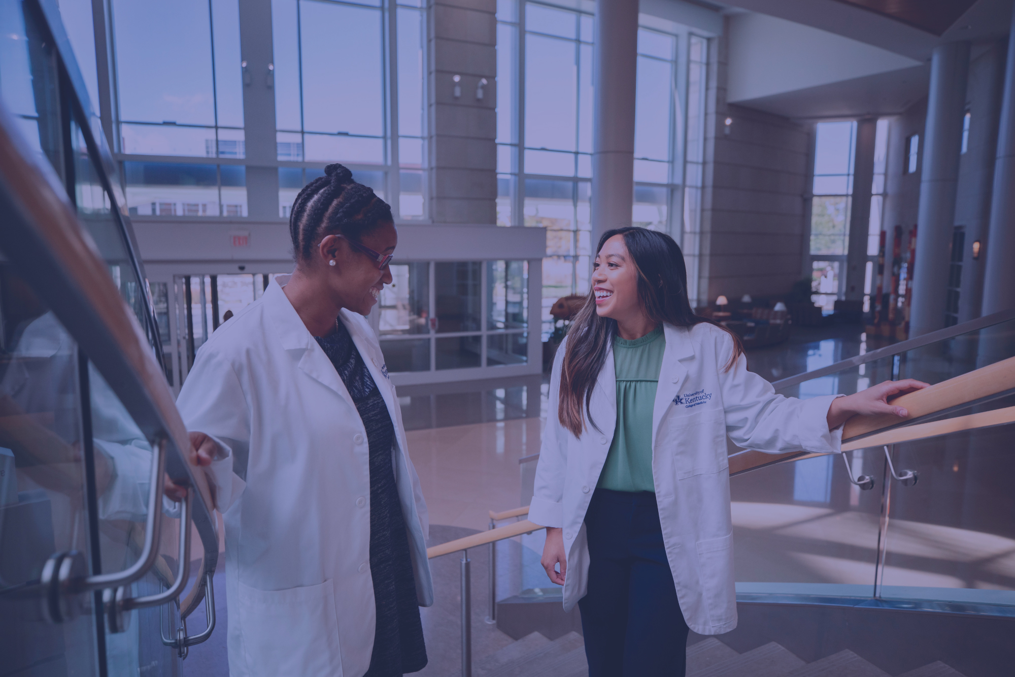 two medical students standing on the stairs at the UK hospital