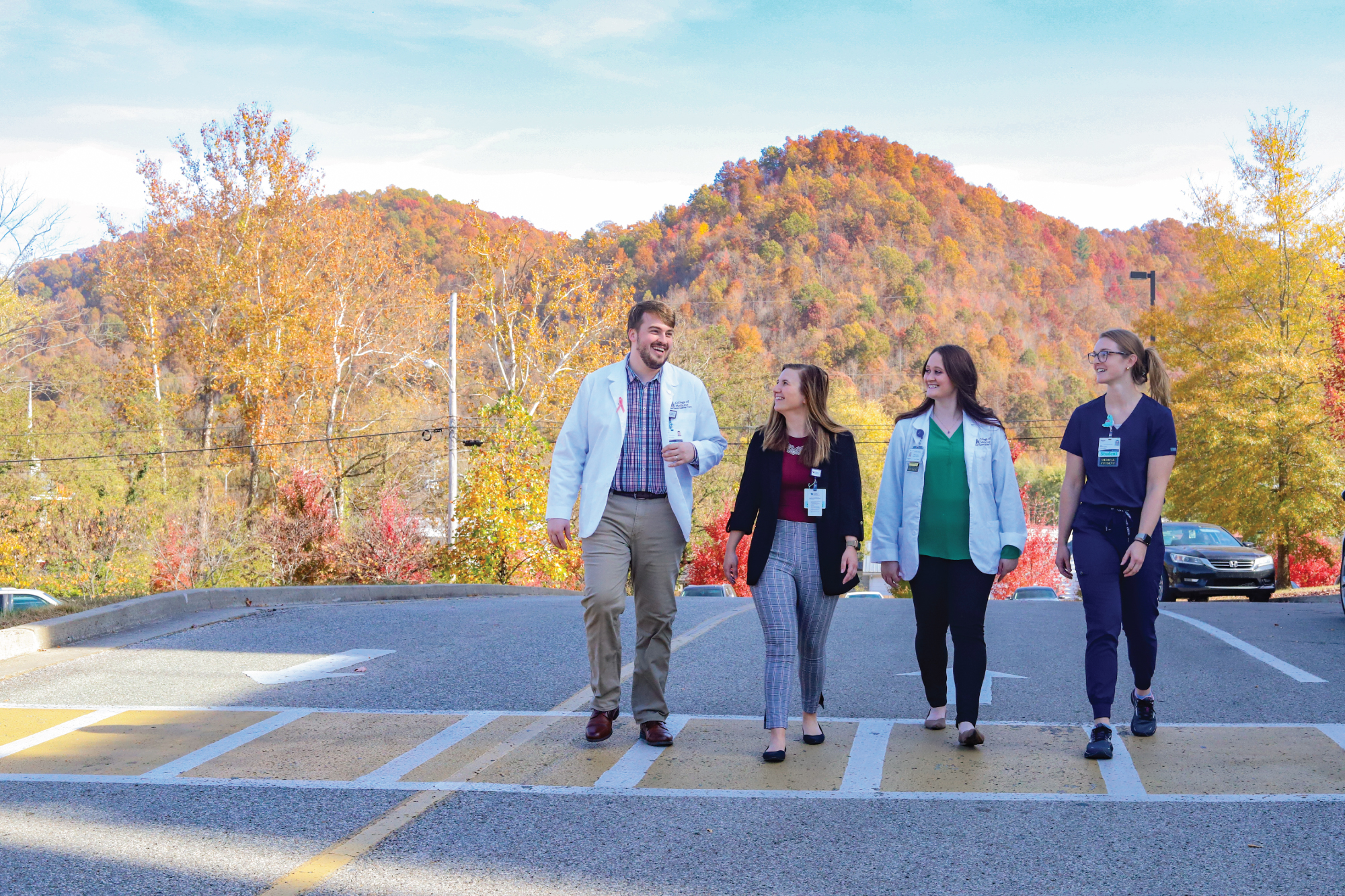 students walking on a street with mountains behind them