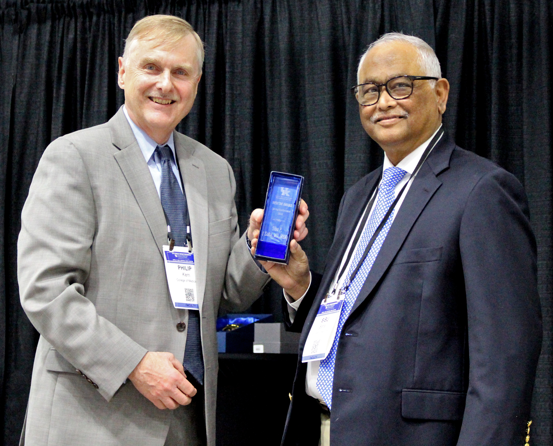 Dr. Philip Kern presents Dr. Sibu Saha with a CCTS Mentor Recognition Award