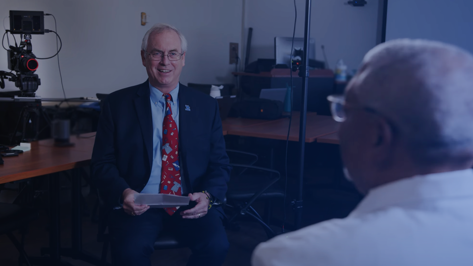 the dean interviewing a department chair in front of a camera