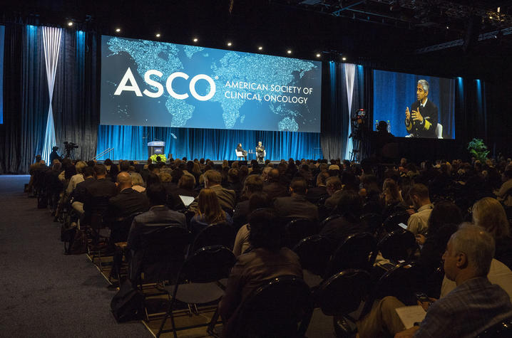 ASCO (American Society of Clinical Oncology) conference room filled with attendees.