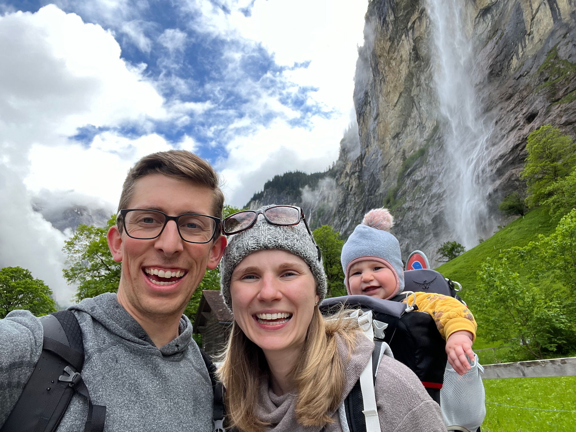 Brenden Garrett with his wife and child, on a hike by a waterfall.