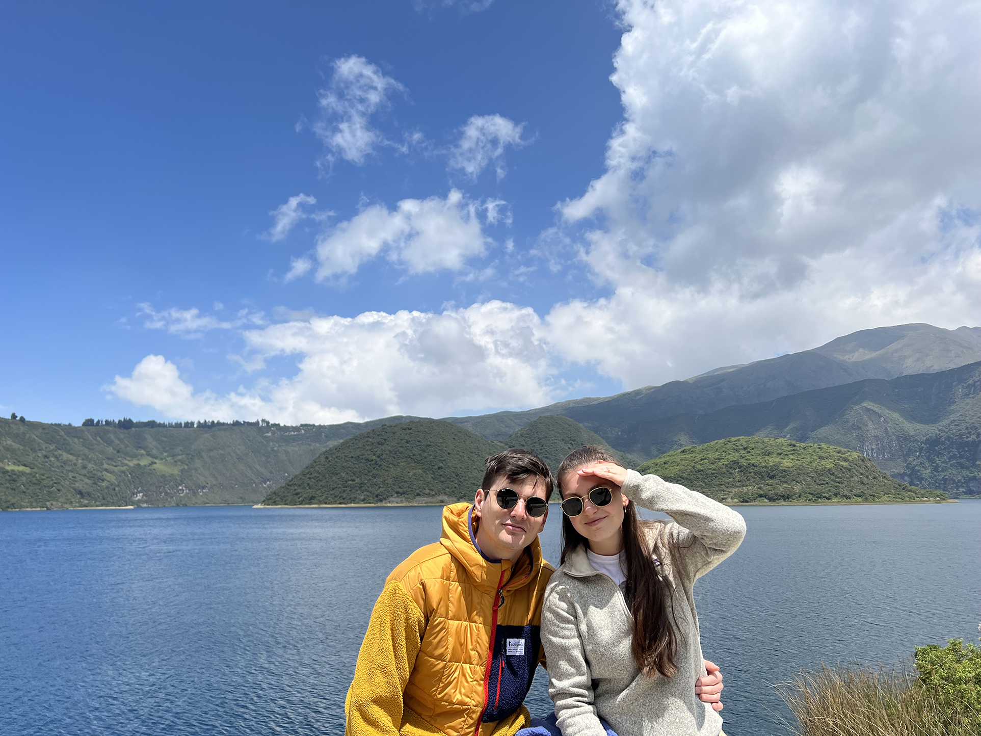 Emily Ranseen and her husband sitting in front of a lake.