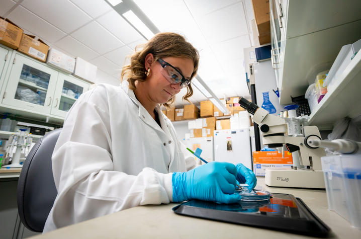 Murphy Byrd with a petri dish in the Ann Stowe laboratory.