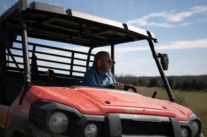 Howard Galbreath driving an ATV vehicle on his farm