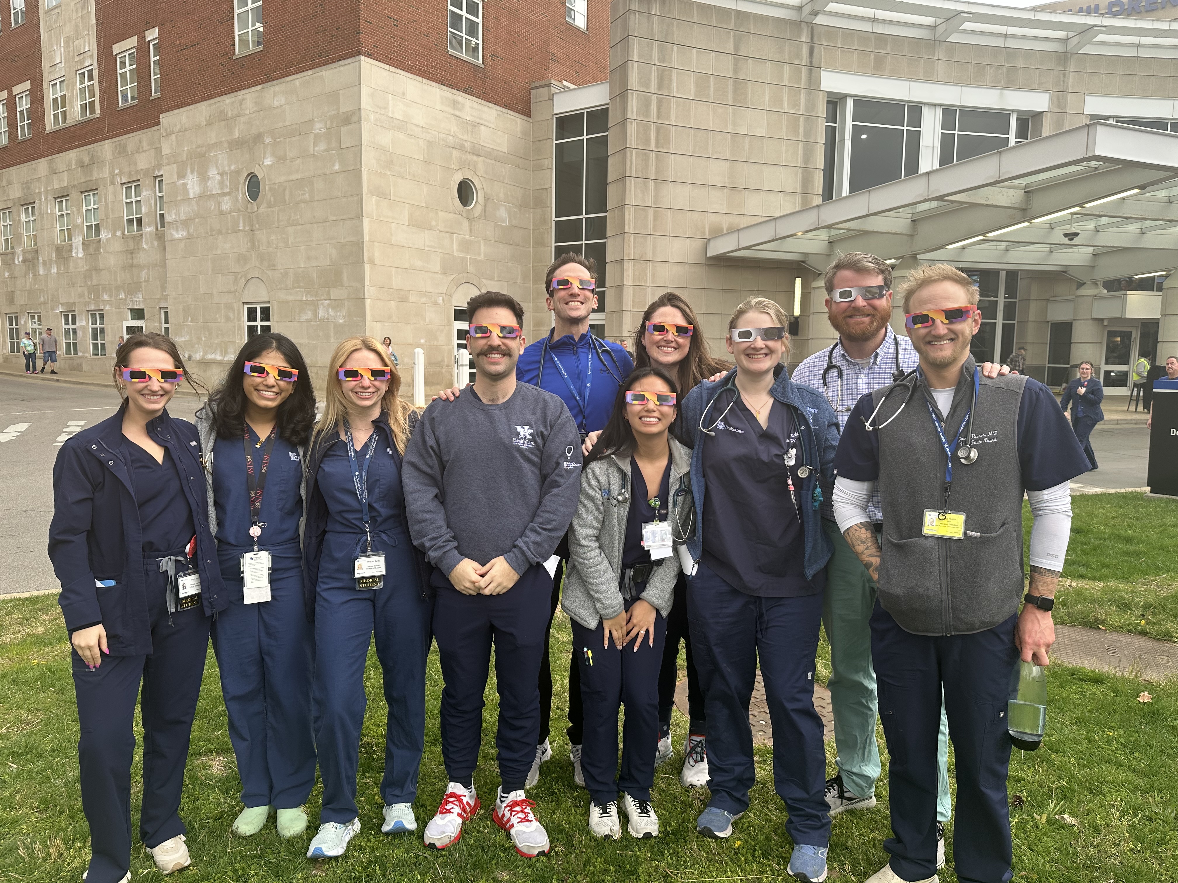 residents watching the 2024 eclipse with eclipse glasses together in community