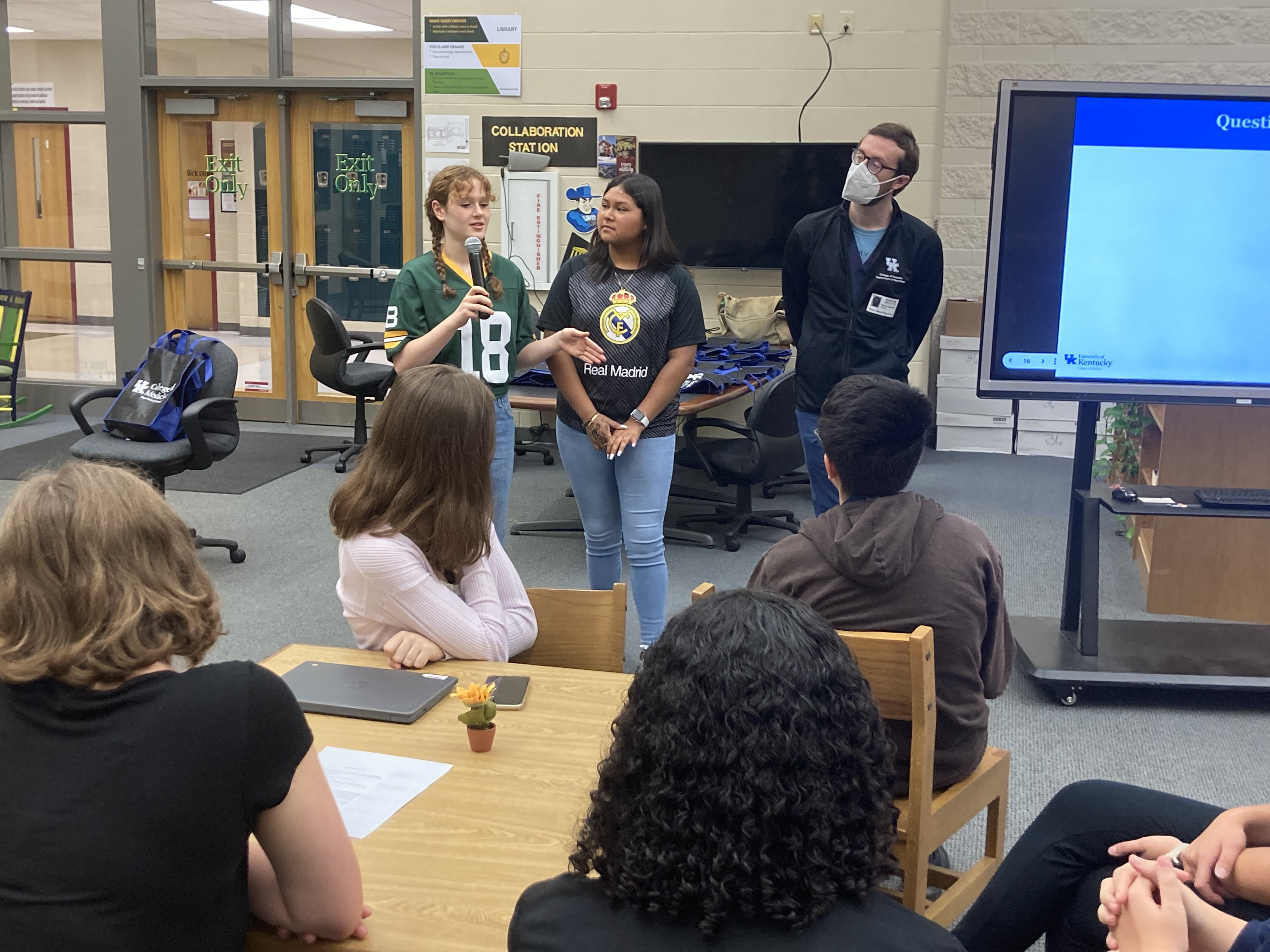 Photo of giving a presentation before a group of students