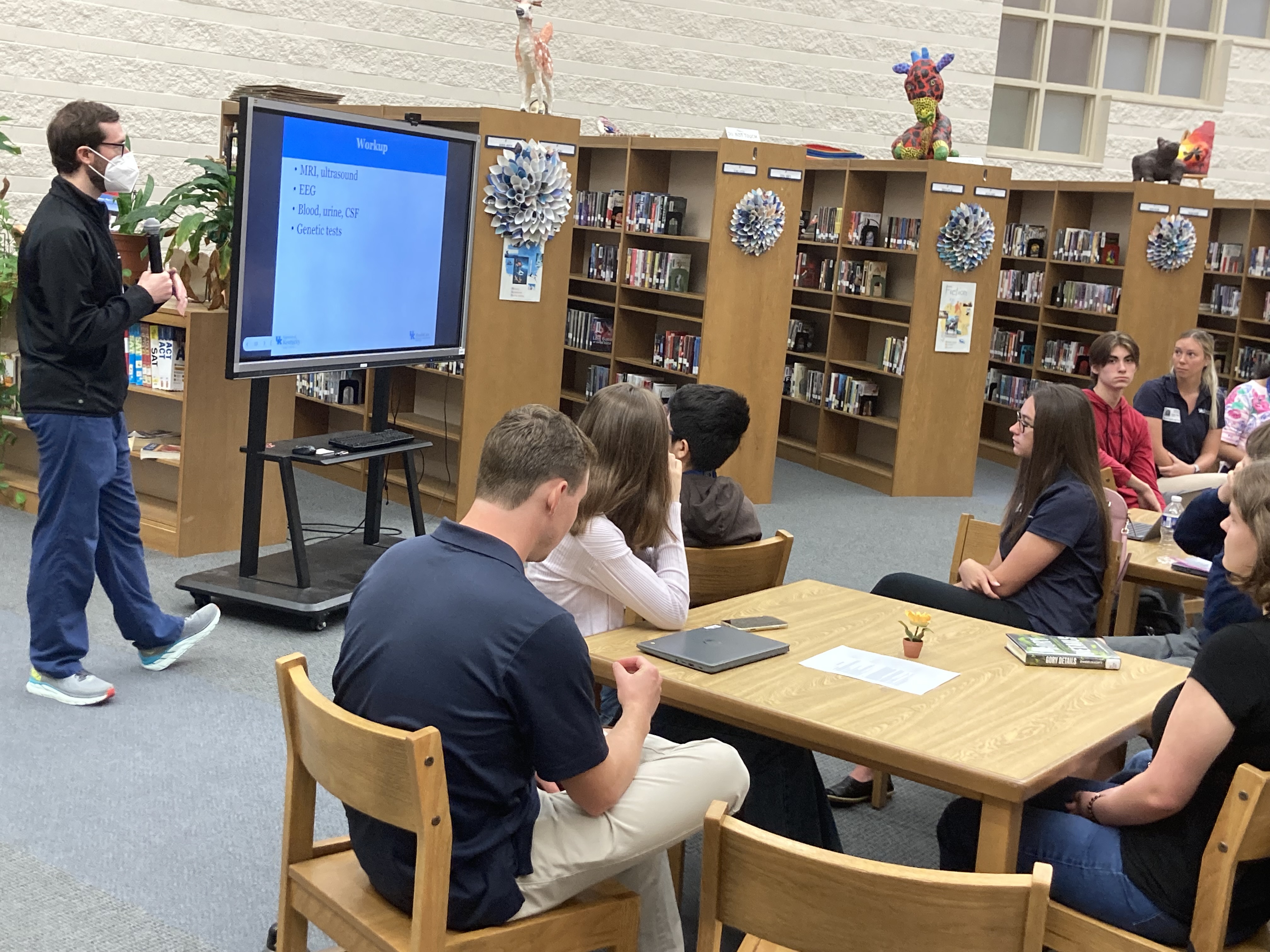 Photo of giving a presentation before a group of students