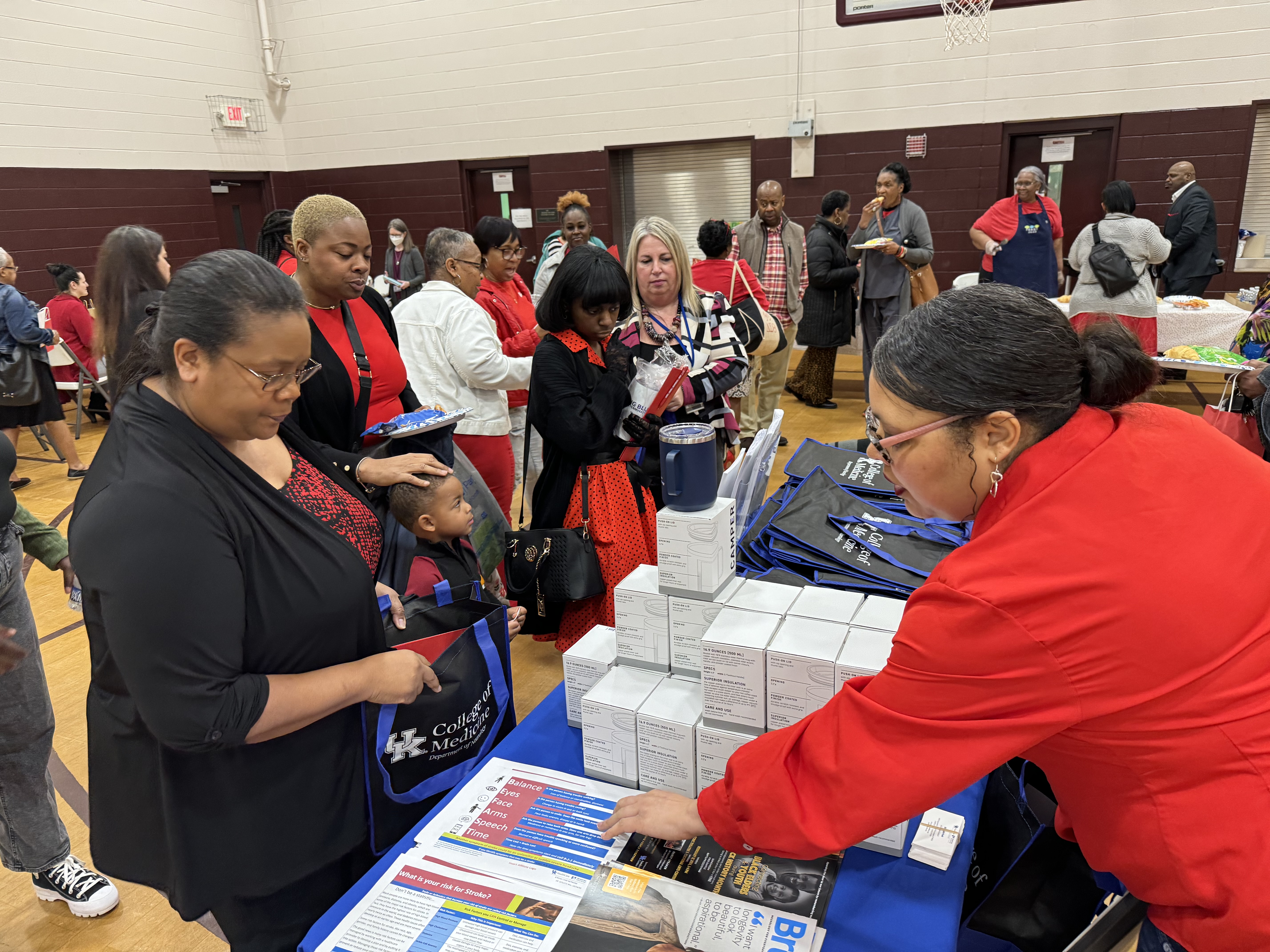 Photo of people lined up at a table for Go Red for Women event