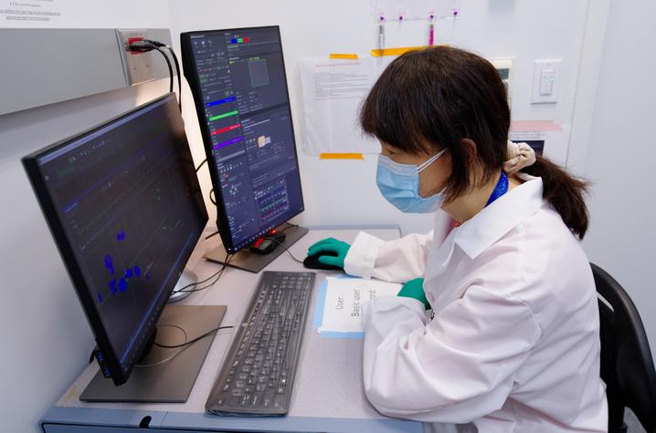 Xia Liu working at a lab computer.