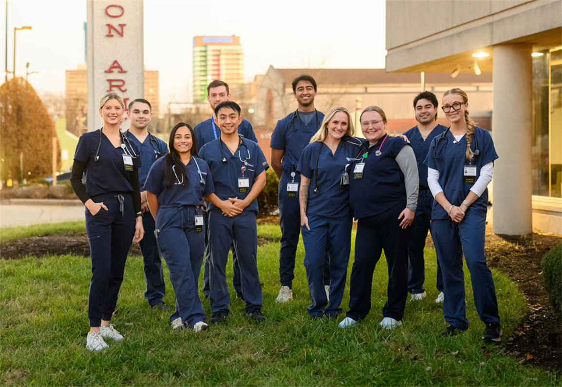 Group of medical student volunteers pose outside Salvation Army Clinic 