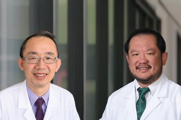 Zhonglin Hao and Eddy Yang in their white coats.