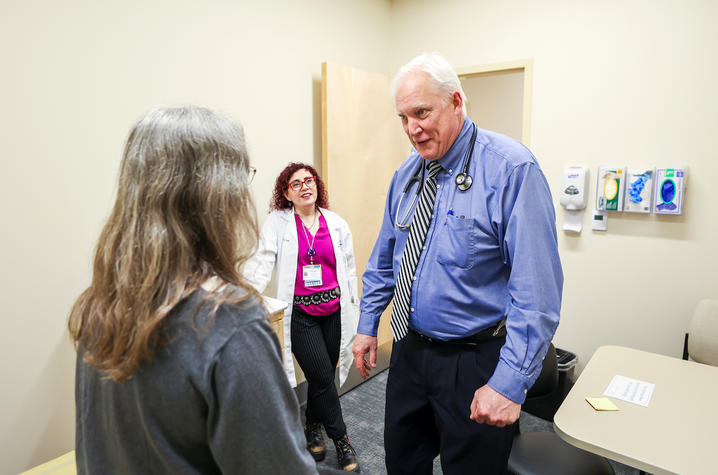Gregory Jicha meets with a clinical trial participant.