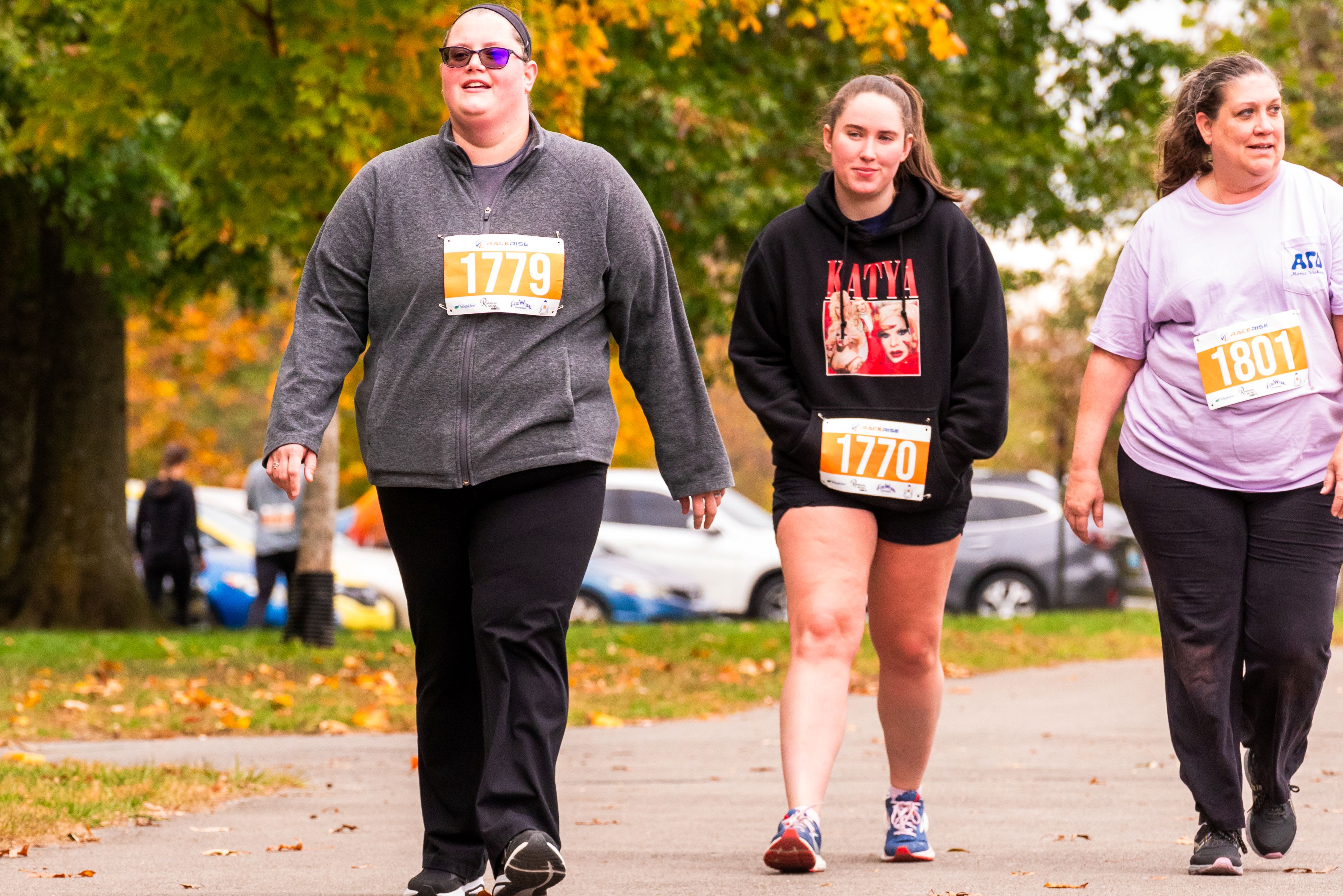 Three women walk confidently in a line