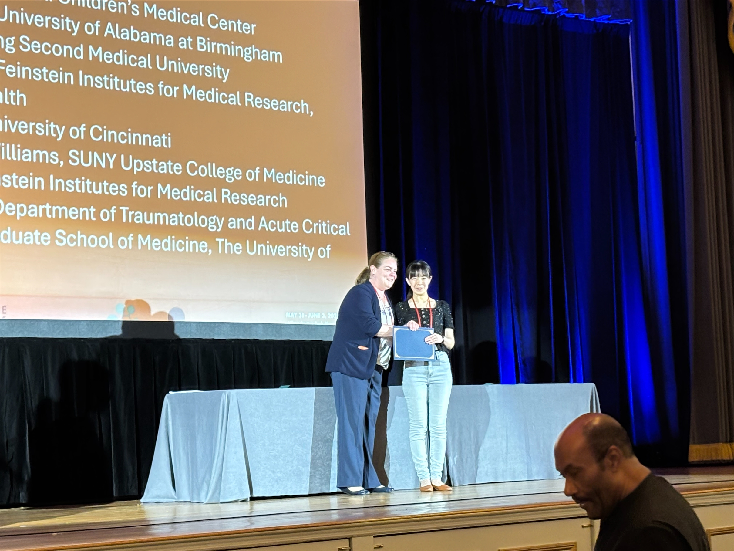 Qian Wang wins an award for her abstract submission at the 48th Shock Society Conference.
