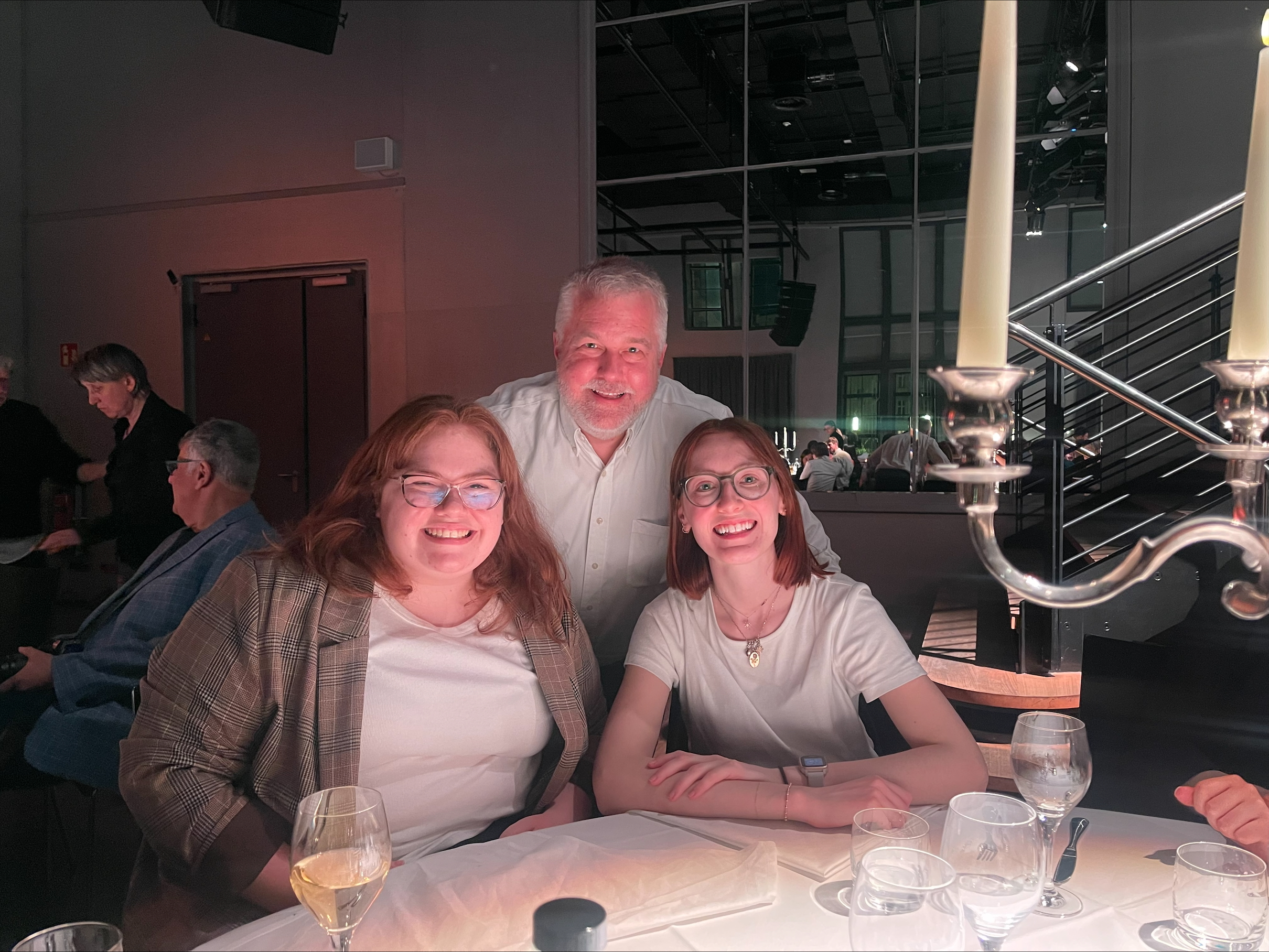 Gracie Eicher and Caroline Hawk with Dr. Ken Fields at dinner. 