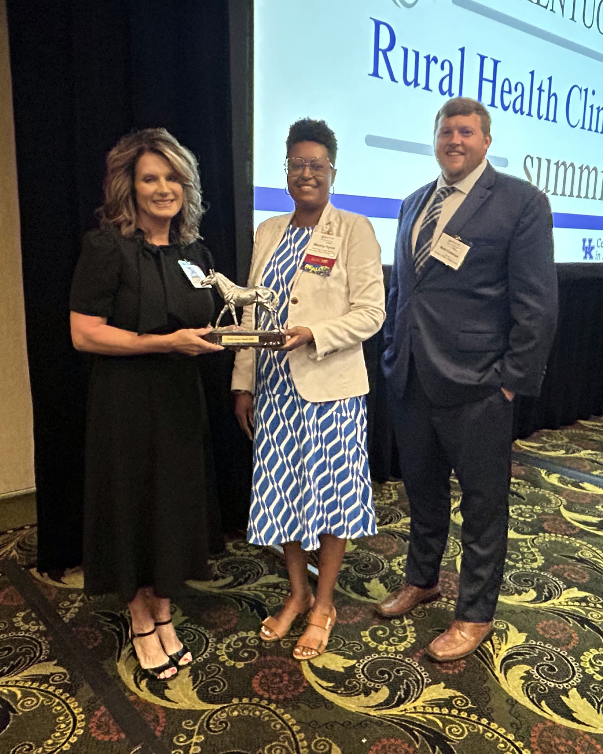 KRMC CEO/CNO Susie Morgan poses with KORH's Matt Coleman and Medina Tipton while accepting the award.