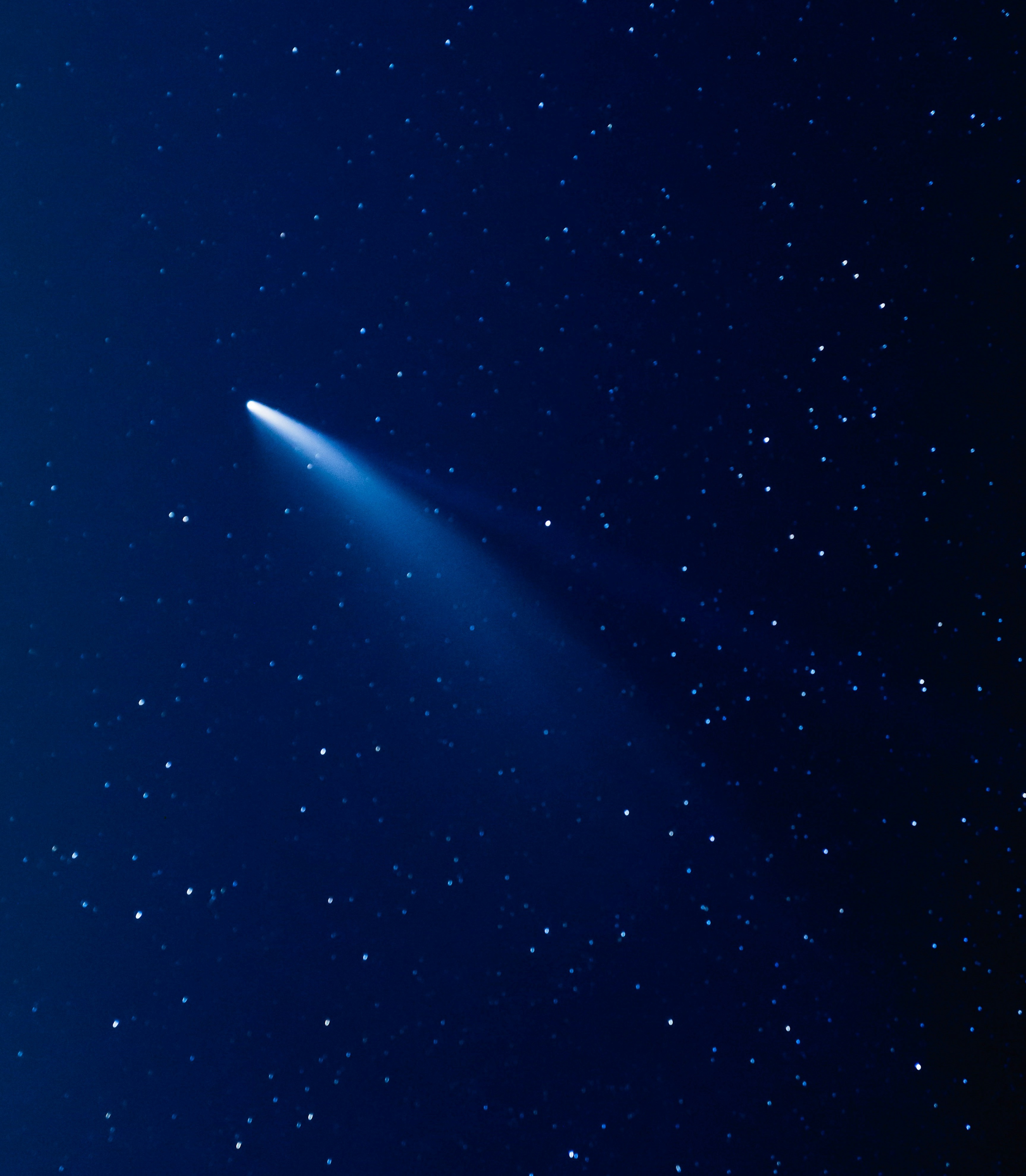 A silvery comet shooting through the night sky.