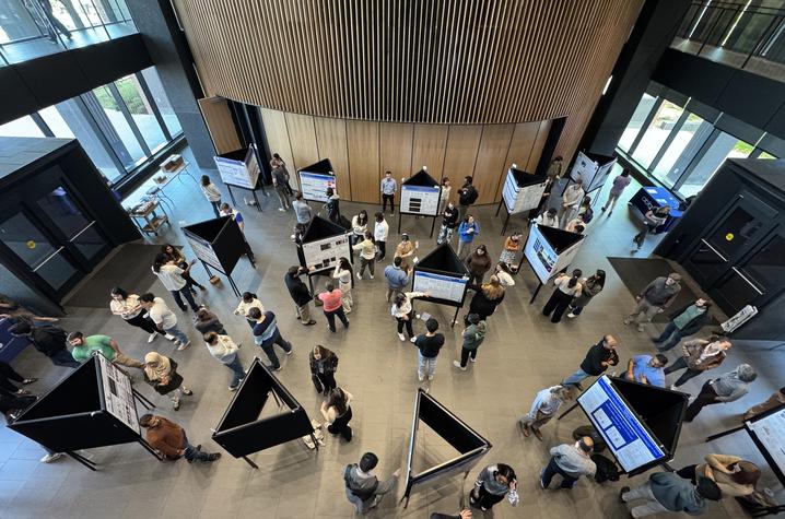 An overhead shot of the 10th annual Neuroscience Symposium, showing individuals conducting poster presentations.