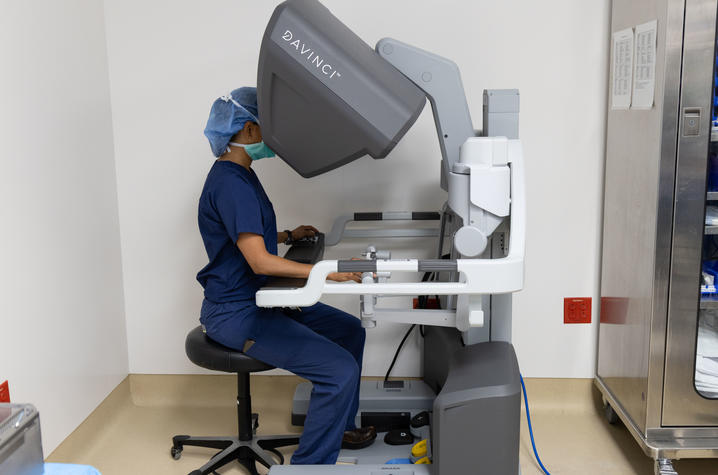 At a control console in the operating room, Shah guides surgical tools through a single, three centimeter incision.