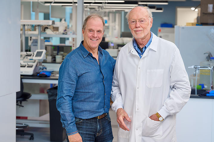 Bill Haney, documentary director, and Phil Sharp standing in Dr. Sharp's lab.