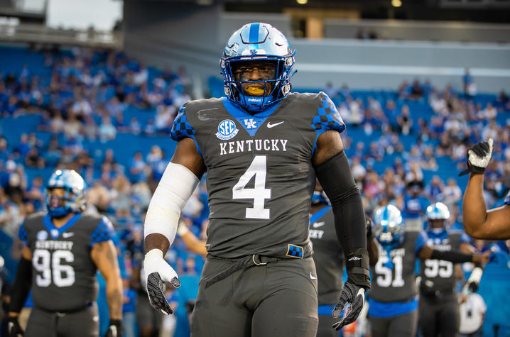 Josh Paschal on the football field in his UK gear. A large number 4 is on his jersey.