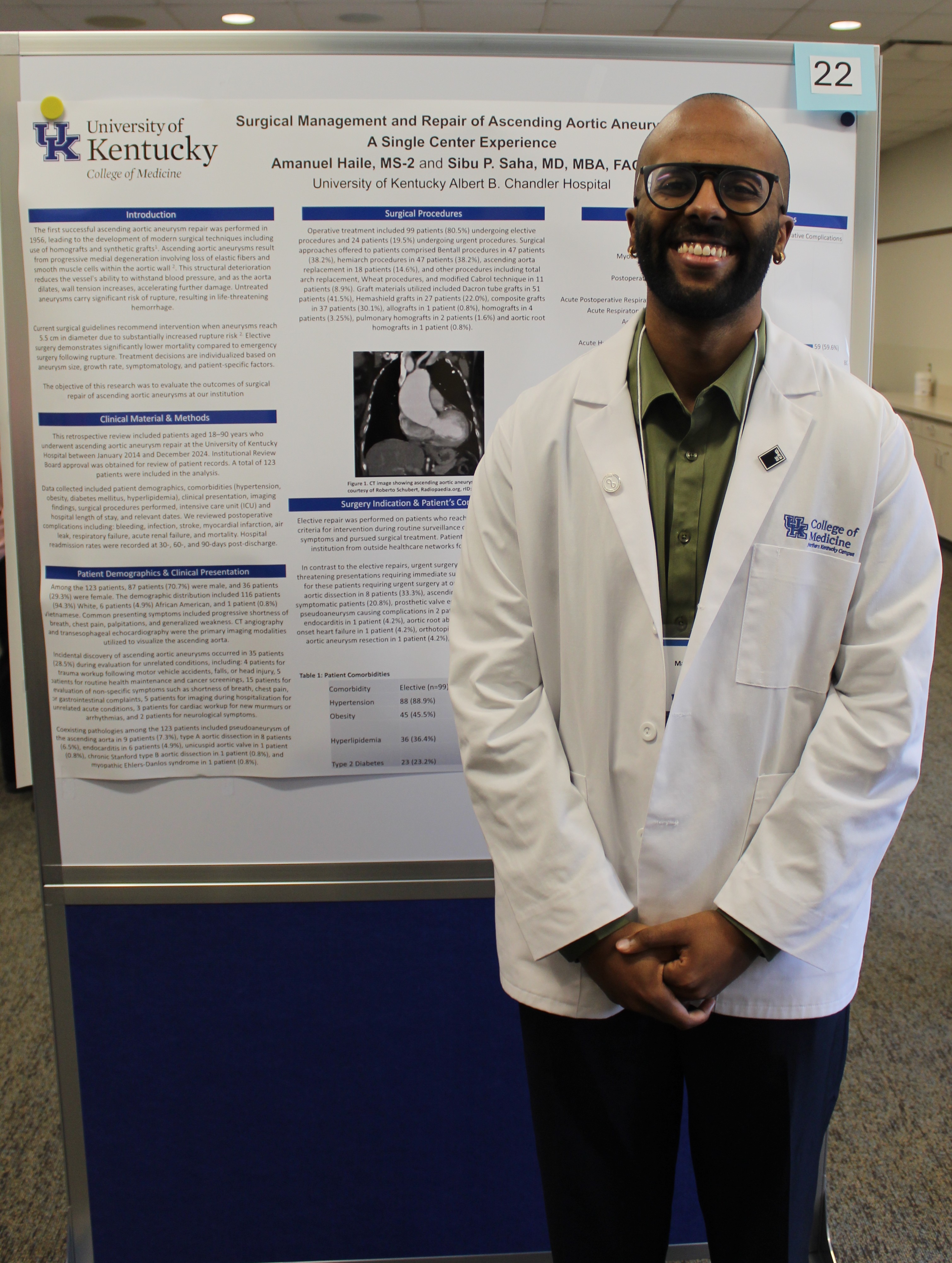 Northern Kentucky Campus medical student wearing white coat smiles in front of research poster.
