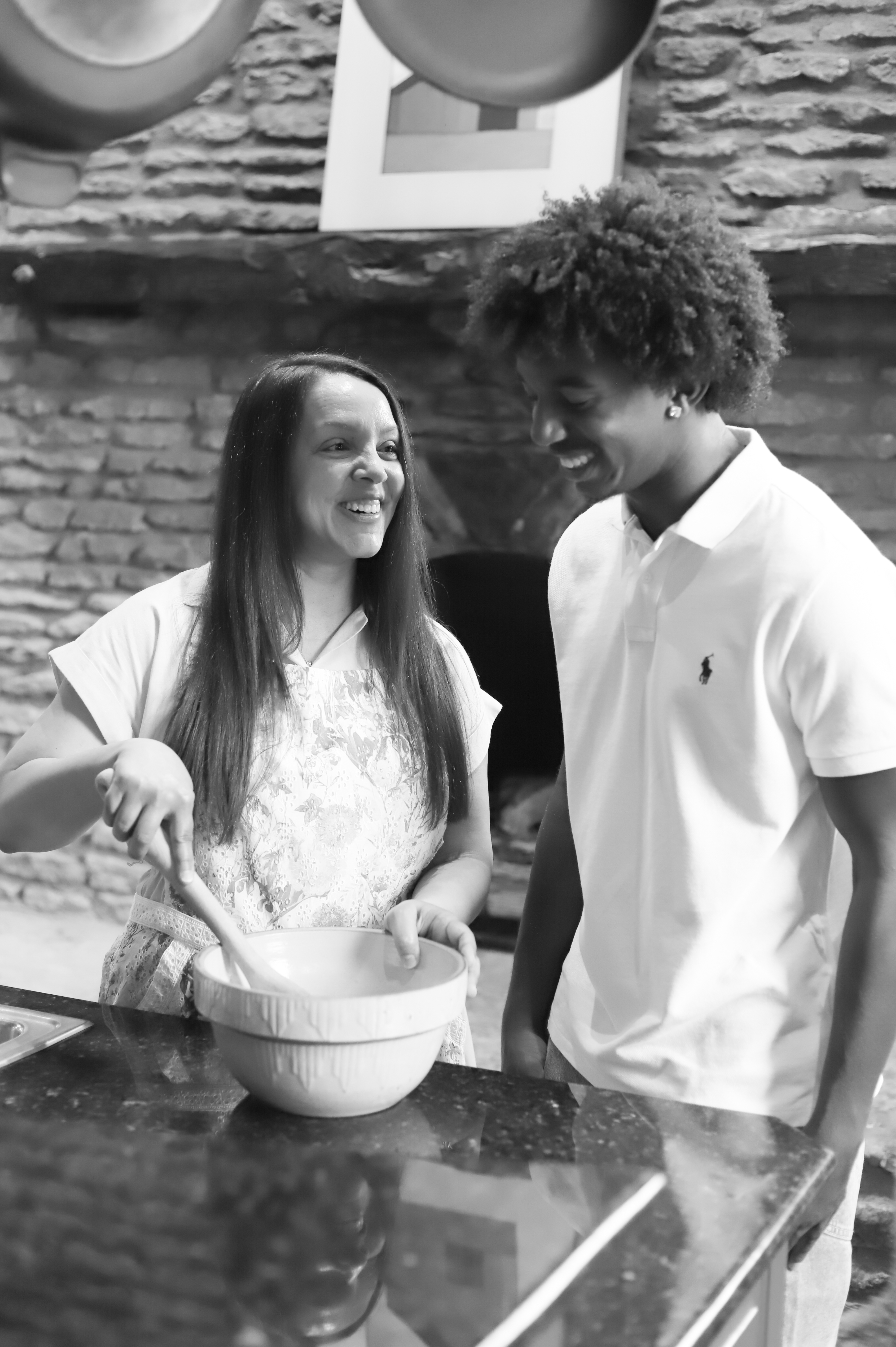 Dr. Jackson and her son look at each other while stirring a bowl in the kitchen