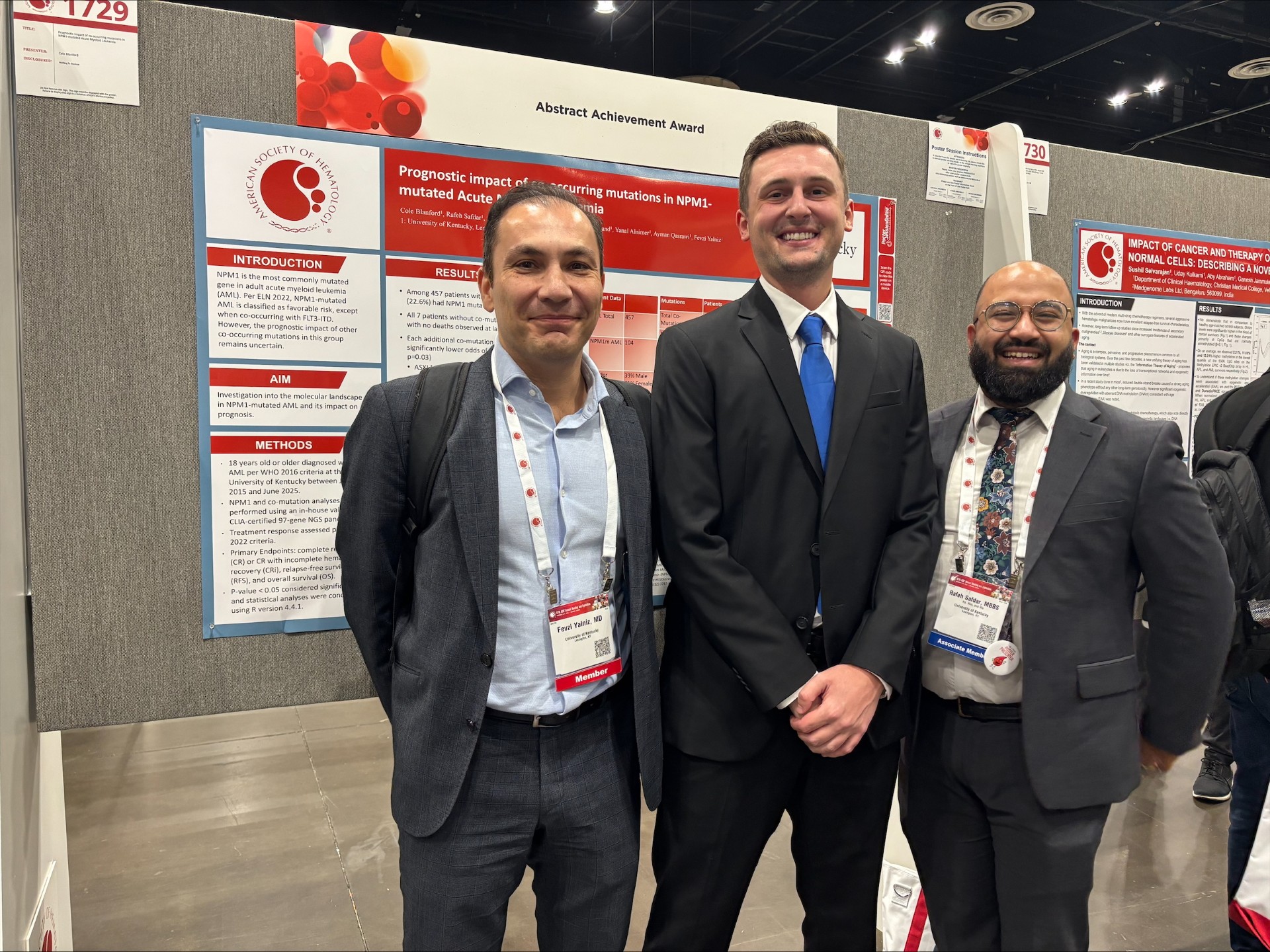 Dr. Yalniz, Blandford, and Safdar stand in front of their abstract posters