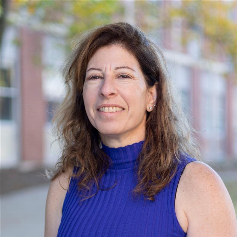 portrait of dr. bonnie firestein, woman with shoulder-length brown hair and blue top